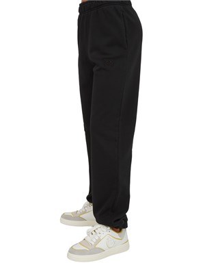 Pantaloni jogger Pinko in cotone nero effetto old con logo in tono in DONNA